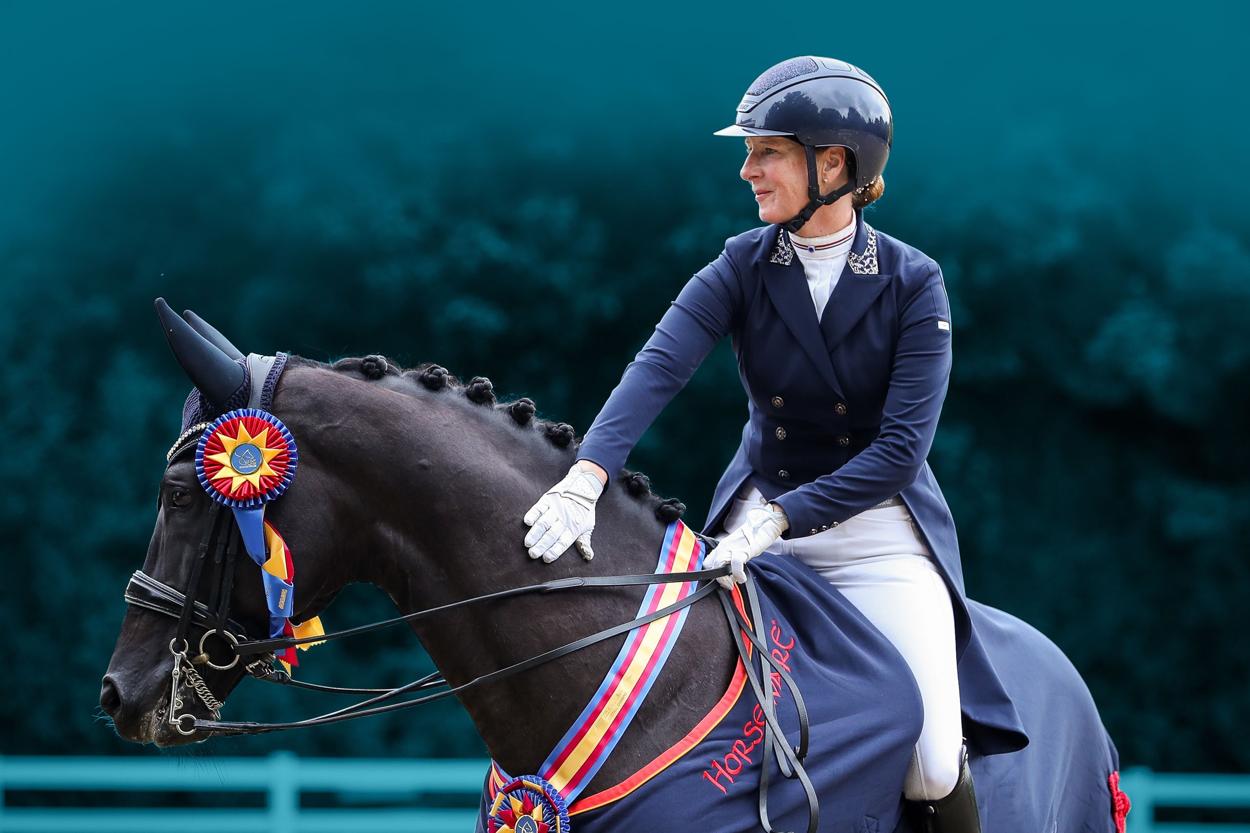 Dressage Rider patting her champion horse