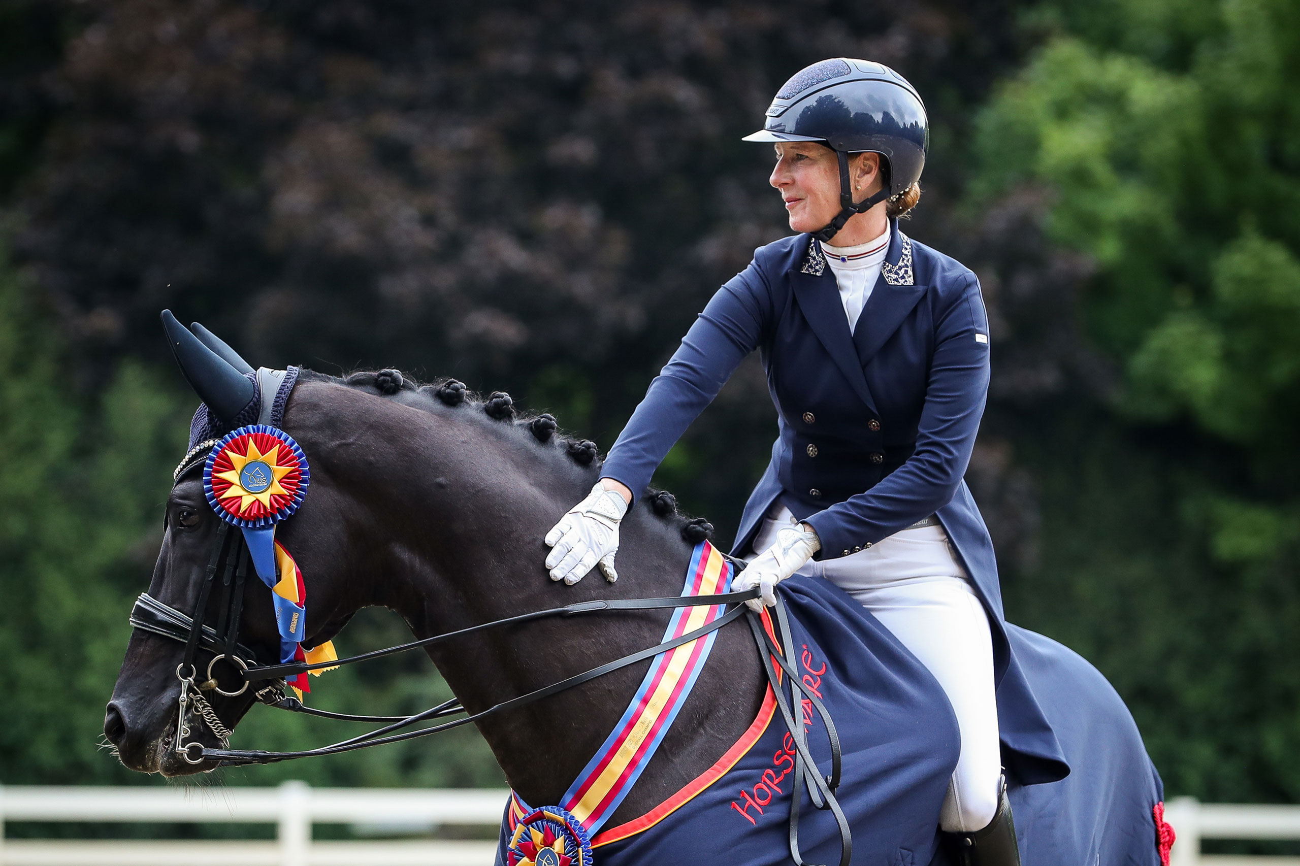 Dressage Rider patting her champion horse